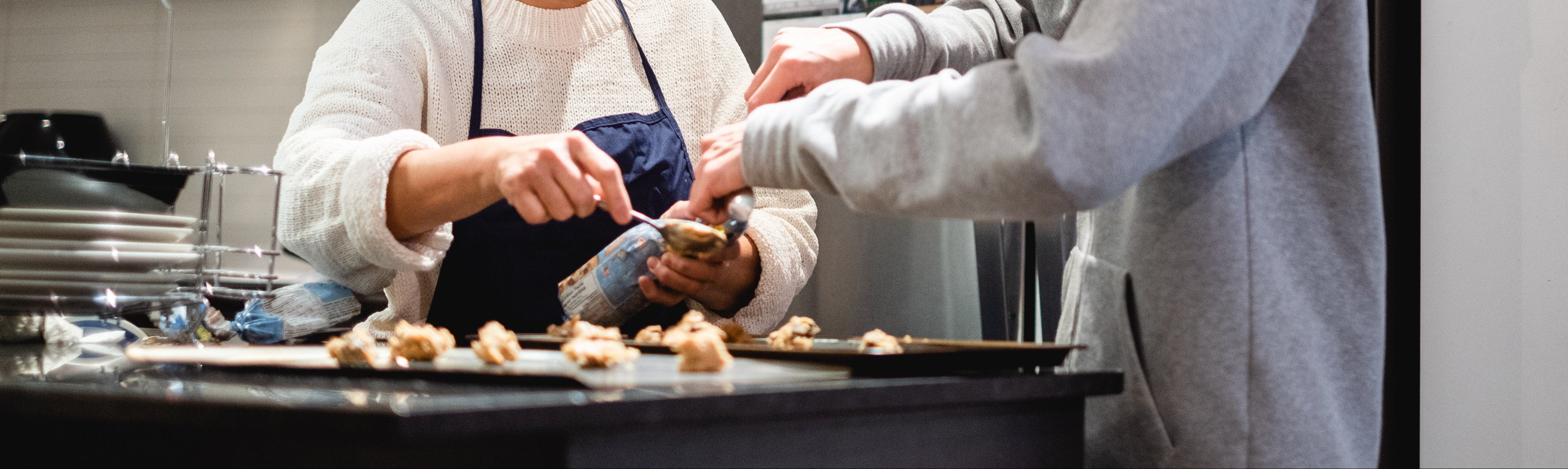 Two people make cookies in there home kitchen
